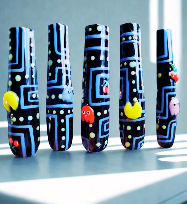 Five nail art designs inspired by retro arcade machine on a light background